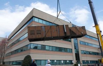 Big crane moving industrial HVAC. JS Thomas team at work.