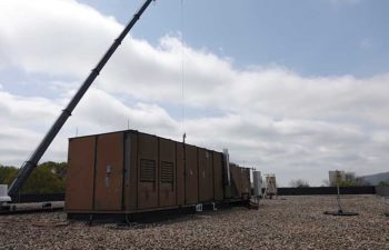 Big crane moving industrial HVAC.