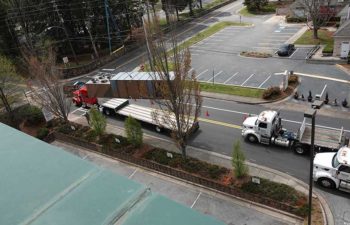 Big crane moving industrial HVAC. Trucks with HVAC units.