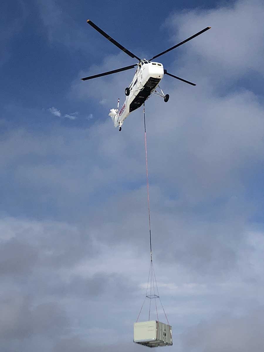 JS Thomas Mechanical air crane transporting HVAC unit.